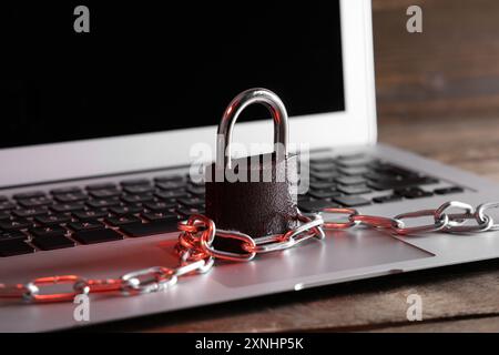 Padlock with chain on laptop, closeup. Cyber security concept Stock Photo