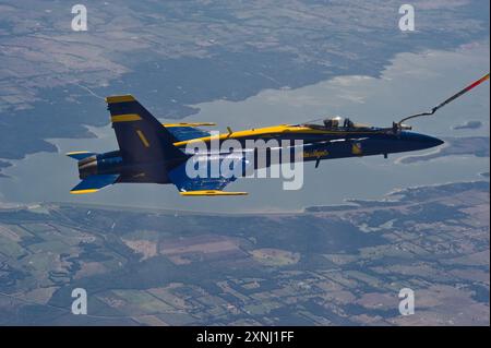 Capt. Greg McWherter, commanding officer of the Blue Angels and flight leader, flies an F/A-18 Hornet during an aerial refueling evolution on the way Stock Photo