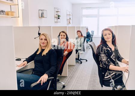 Team of Women Providing Customer Support in Call Center Environment. Stock Photo