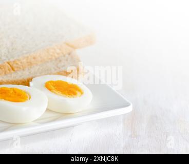 Boiled egg and toasts on white plate Stock Photo