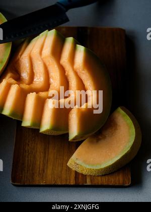 melon cut into slices on a cutting board Stock Photo