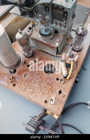 Parts of an old radio with traces of time. Radio tubes, transistors and so on. Rusty base Stock Photo