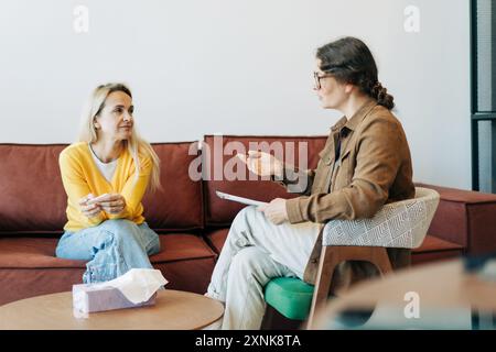 Psychological counseling scene. A psychologist conducts a session with a patient in the office. Stock Photo