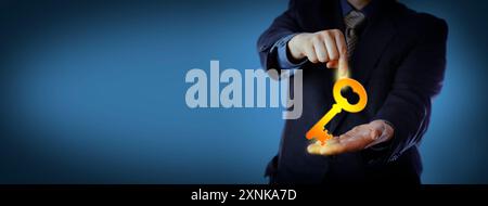 Unrecognizable businessman in blue is pointing at a virtual key that he is holding in his open palm. Business concept for turnkey solution, leadership Stock Photo