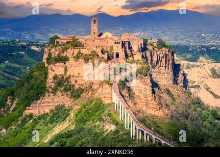 Bagnoregio, Italy. Dusk light over Civita di Bagnoregio, hilltop town founded by Etruscans in Valle dei Calanchi, Viterbo province, Lazio region. Stock Photo