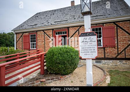 LURAY, Virginia, United States — The Elk Run Meeting House stands at the Shenandoah Heritage Village, showcasing Moravian-style architecture from the early 19th century. Originally constructed around 1800 in Millcreek, VA, this historic structure is built of heartpine and brick. The relocated building now serves as an educational exhibit, illustrating religious and architectural history of the Shenandoah Valley region. Stock Photo