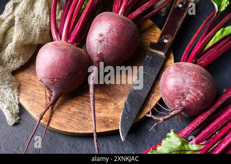 Ripe fresh beets on a wooden cutting board with knife. Food photography Stock Photo