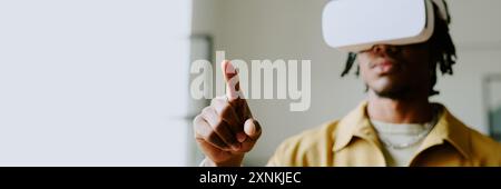 Medium closeup of young African American male developer wearing VR headset testing new software, copy space, header for website Stock Photo