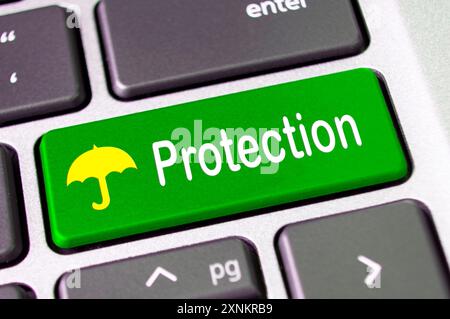 Protection text on green keyboard with umbrella symbol. Stock Photo