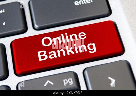 Online banking text on red laptop keyboard button. Banking and transaction in digital form concept. Stock Photo