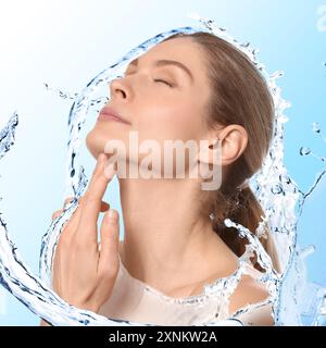 Attractive woman and splashes of water on gradient background Stock Photo