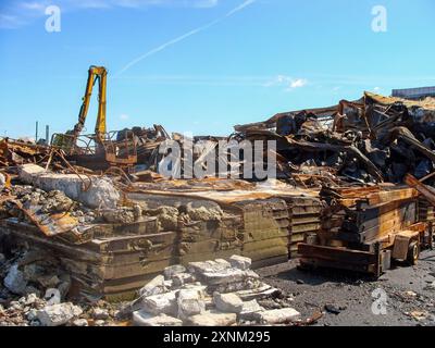 Burnt remains of an industrial site after a fire, with debris and damaged structures Stock Photo