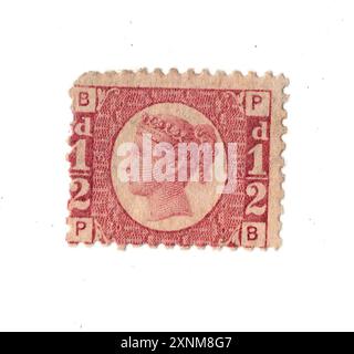 A vintage Queen Victoria half penny postage stamp from Great Britain on a white background. Stock Photo