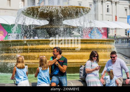 London, UK. 1st Aug, 2024. The mini heatwave hangs on and causes people to use the water in the fountains of Trafalgar Square to cool down. Credit: Guy Bell/Alamy Live News Stock Photo