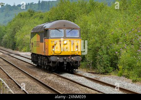 Pontyclun, Wales, UK. - 31 July 2024:  Class 56 diesel locomotive operated by Colas Rail Freight running alone without trucks near Pontyclun in south Stock Photo