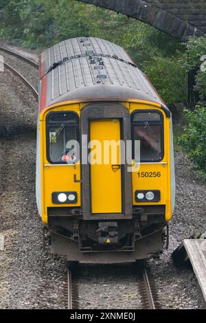 Pontyclun, Wales, UK. - 31 July 2024:  Class 150 diesel commuter train operated by Transport for Wales approaching the railway station in the village Stock Photo