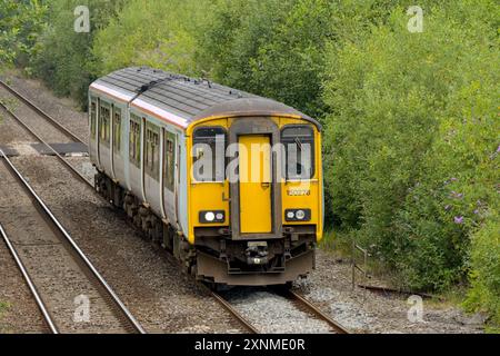 Pontyclun, Wales, UK. - 31 July 2024:  Class 150 diesel commuter train operated by Transport for Wales approaching the railway station in the village Stock Photo