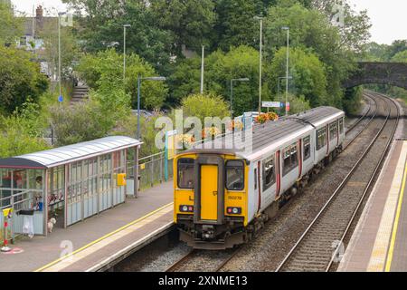 Pontyclun, Wales, UK. - 31 July 2024:  Class 150 Sprinter diesel commuter train leaving the railway station in the village of Pontyclun in south Wales Stock Photo