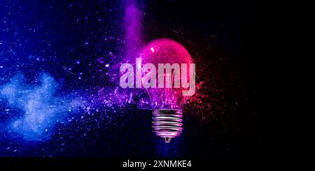 light bulb  exploding blue pink powder  black background Stock Photo