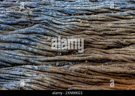 Solidified lava flow shows texture of wrinkles and lines Stock Photo