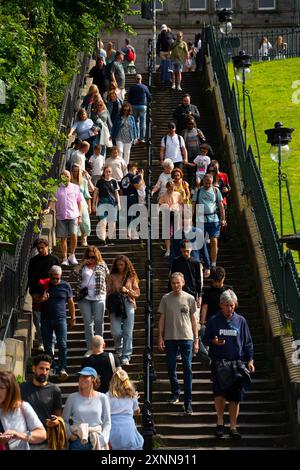 Edinburgh, Scotland, UK. 1 August 2024.  Street scenes in Edinburgh Old Town ahead of the opening of the Edinburgh International Festival and Fringe Festival tomorrow, 2nd August. Pic; Public climbing the Playfair Steps in Princes Street Gardens.  Iain Masterton/Alamy Live News Stock Photo