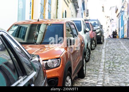 Salvador, Bahia, Brazil - July 27, 2024: View of cars parked along the sidewalk on a street in Pelourinho, historic center of Salvador, Bahia. Stock Photo