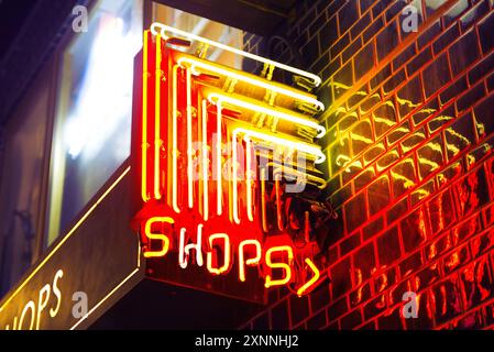 Red and yellow neon shops sign in Hong Kong at night Stock Photo