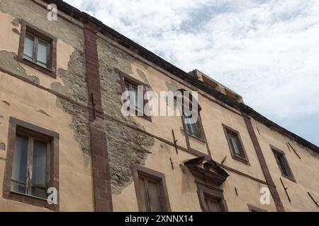 Weathered Historic Building Facade with Exposed Stone Stock Photo