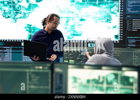 Cyber intelligence team using advanced technology to secure computer networks, governmental espionage system. Emphasizing cyber security and threat detection to combat cyberterrorism. Stock Photo
