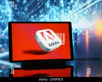 In this photo illustration,  Adobe Inc.  logo seen displayed on a tablet. Stock Photo