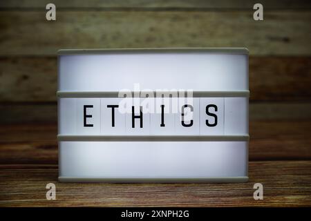 ETHICS letterboard text on LED Lightbox on wooden background, Business concept background Stock Photo