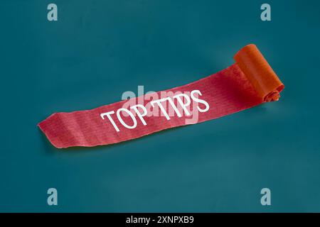 Top tips. Inscription TOP TIPS word on a piece of an unfolded note Stock Photo