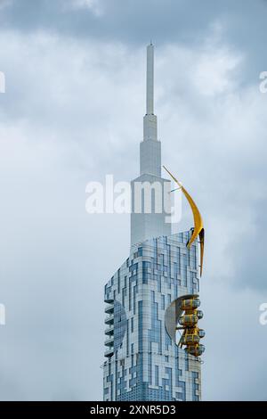 Modern architectural detail of the Batumi Tower in Georgia, featuring its distinctive ferris wheel integrated into the building design. Stock Photo