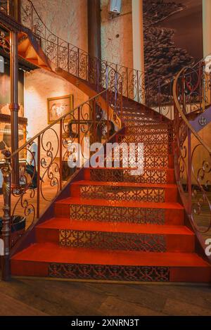 Grand Staircase with Red Carpet and Wrought Iron Railings in Luxury ...
