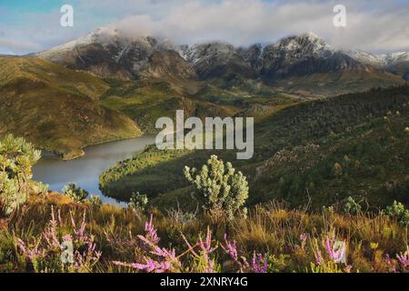 Elandskloof pass with Elandskloof dam with snowcapped mountains and fynbos near Villiersdorp. Stock Photo