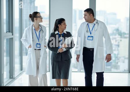 Doctors Discussing Working Moments With Manager Stock Photo