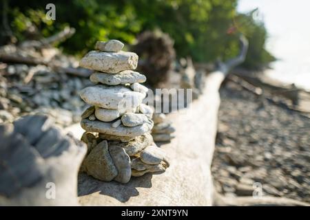 Balancing stones stacks on pebble beach near Valaste waterfall, reached by a wooden staircase, on the shore of Gulf of Finland, northern Estonia. Stock Photo