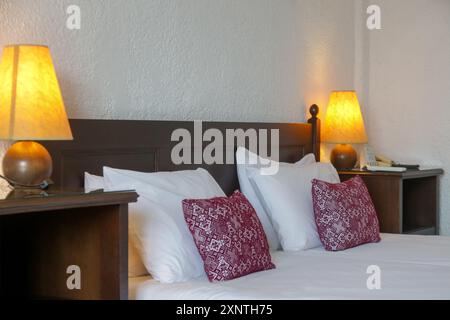 Retro bedroom style with red pattern pillows on bed Stock Photo
