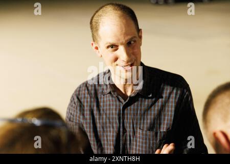 Evan Gershkovich greets colleagues from the Wall Street Journal at Andrews Air Force Base, after he was released from Russian prison as part of a prisoner swap, on Thursday, August 02, 2024. Credit: Aaron Schwartz/CNP /MediaPunch Stock Photo