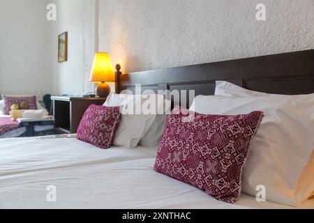 Retro bedroom style with red pattern pillows on bed Stock Photo
