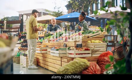 Portrait of a Young Handsome Customer Shopping for Organic Seasonal Fruits and Vegetables for a Healthy Breakfast. Multiethnic Man Buying Sustainable Bio Oranges From a Local Street Vendor Stock Photo