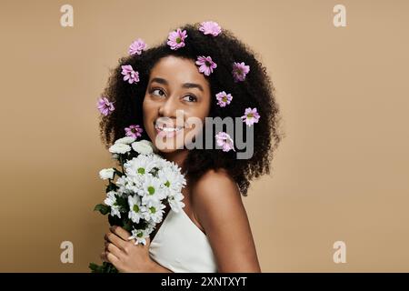 African American woman holds bouquet of flowers smiling Stock Photo - Alamy
