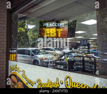 A sign in the window of a grocery in Chelsea in New York announces that the convenience store accepts EBT (electronic benefit transfer) funds, seen on Monday, July 29, 2024. (© Richard B. Levine) Stock Photo