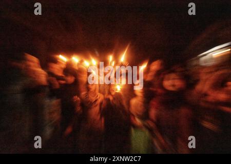 Kashmiri Shia Muslim women and small girls hold candles and shout pro-Palestine and anti-Israel slogans during a candlelight demonstration rally. A candlelight rally was held on the outskirts of Srinagar following the assassination of Ismail Haniya, one of the top political leaders of Hamas, who was killed in Tehran, the capital of Iran. Both Iran and Hamas have blamed Israel for the assassination. Demonstrators expressed solidarity with the affected communities, condemning the violence, and calling for justice and an end to sectarian attacks. (Photo by Mubashir Hassan/Pacific Press) Stock Photo