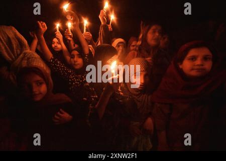 Kashmiri Shia Muslim women and small girls hold candles and shout pro-Palestine and anti-Israel slogans during a candlelight demonstration rally. A candlelight rally was held on the outskirts of Srinagar following the assassination of Ismail Haniya, one of the top political leaders of Hamas, who was killed in Tehran, the capital of Iran. Both Iran and Hamas have blamed Israel for the assassination. Demonstrators expressed solidarity with the affected communities, condemning the violence, and calling for justice and an end to sectarian attacks. (Photo by Mubashir Hassan/Pacific Press) Stock Photo