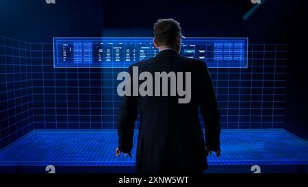 Business Analyst Working in a Virtual Reality Office with Augmented Reality Screens. Manager Using a Virtual Touch Screen Hologram with Multiple Options, Generating Visual Presentations from Big Data Stock Photo