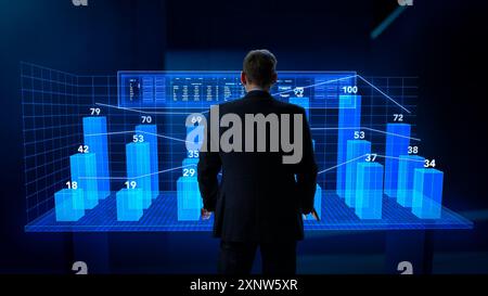 Business Analyst Working in Virtual Reality Office with Augmented Reality Screens. Manager Using a Virtual Touch Screen Hologram with Multiple Options, Generating Presentations With Graphs, Charts Stock Photo