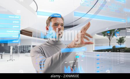 Handsome Man Standing in Futuristic Virtual Space, Interacting with an Augmented Reality Hologram with Business Data, Financial Reports, Stock Market Statistics, Infographics and Charts Stock Photo