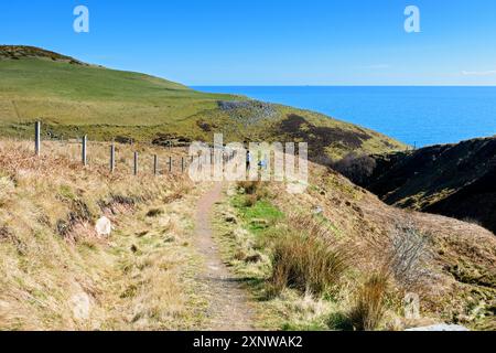 A walker on the path approaching Ousdale Broch, an Iron Age broch near the village of Ousdale, Caithness, Scotland, UK, Stock Photo