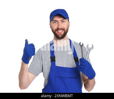Professional auto mechanic with tools showing OK gesture on white background Stock Photo